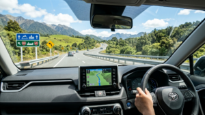 Rental car driver following New Zealand road signs and navigation