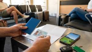 Traveler preparing documents before airport rental car pickup