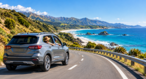 Rental SUV traveling through New Zealand summer coastal scenery
